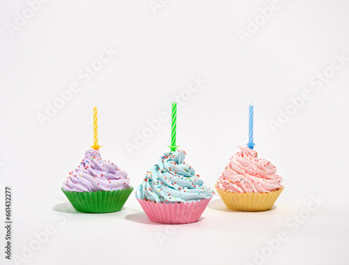 Different types of birthday cupcakes on table. Tasty cupcakes with birthday candles. Concept of celebrate.