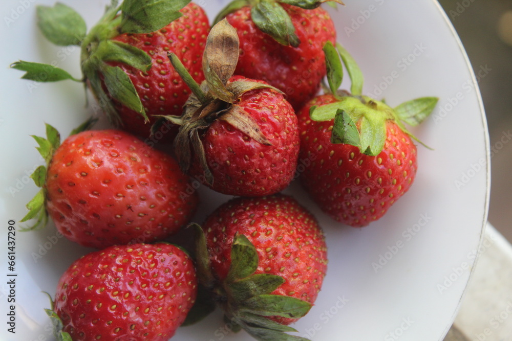 some fresh strawberries in a small plate some fresh strawberries in a small plate
