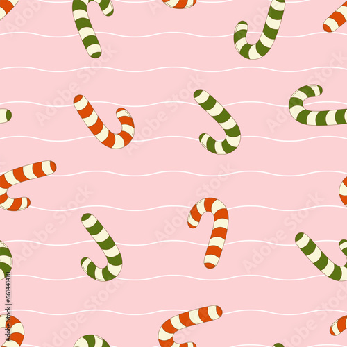 Seamless pattern of groovy candy cane in retro style on a pink background. Vector illustration for design, textiles, wrapping paper, cards. 