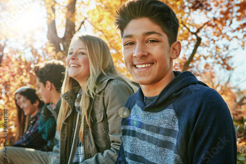 Teenager, friends and portrait in outdoor, boy and diversity on holiday, nature and relax by trees. Youth culture, happy group and gen z school kids in sunshine, woods or park for vacation in Canada