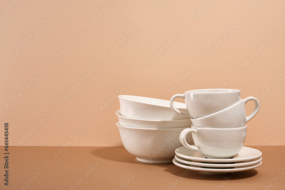 Set of clean white empty tableware. Clean cups and plates. Copy space for text.