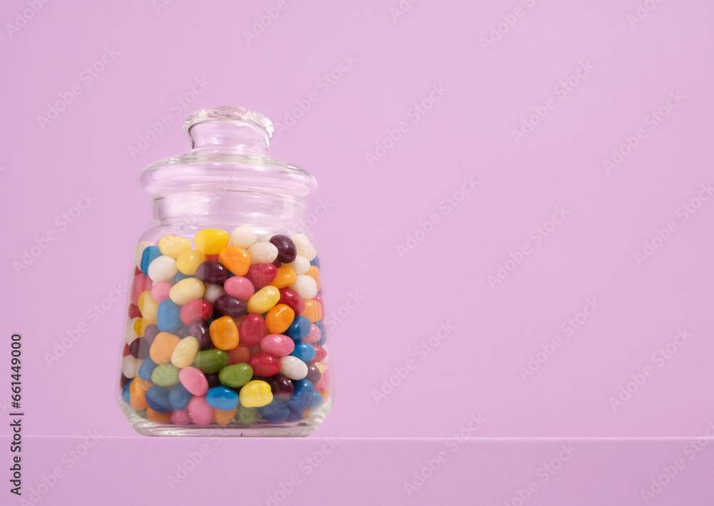 A glass jar of colorful delicious candy. Copy space for text. A glass jar of colorful delicious candy. Copy space for text.