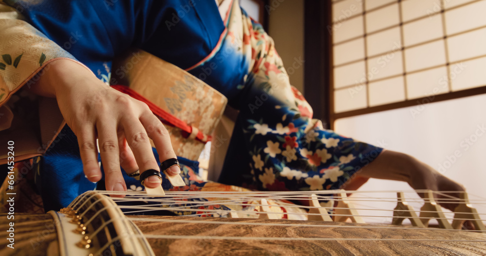 Authentic Japanese Koto Player Practising the Art of String Music in Her Traditional Home. Musician in Blue Kimono Using a Long Japanese Board Zither with 13 Silk Strings and Movable Bridges - obrazy, fototapety, plakaty 