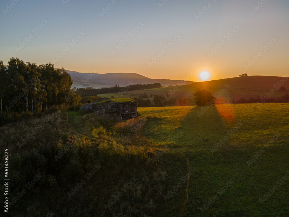 Fototapeta premium Concrete bunker in czech mountains during sunrise. Orlicke hory.