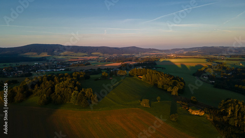 Landscape of czech nature with mountains, meeadows, forest and city in valley. Orlicke hory.