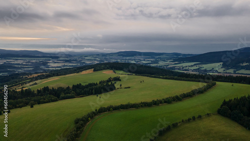 Aerial view of Orlicke hory with meadows and forests during cloudy day.