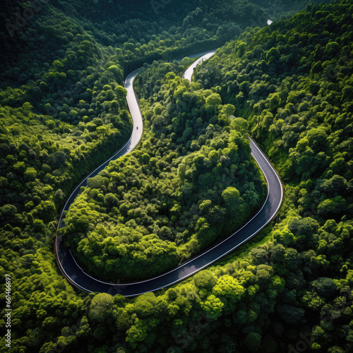 Winding road, top view of beautiful aerial view of asphalt road, highway through forest. For traveling and driving in nature © mirexon