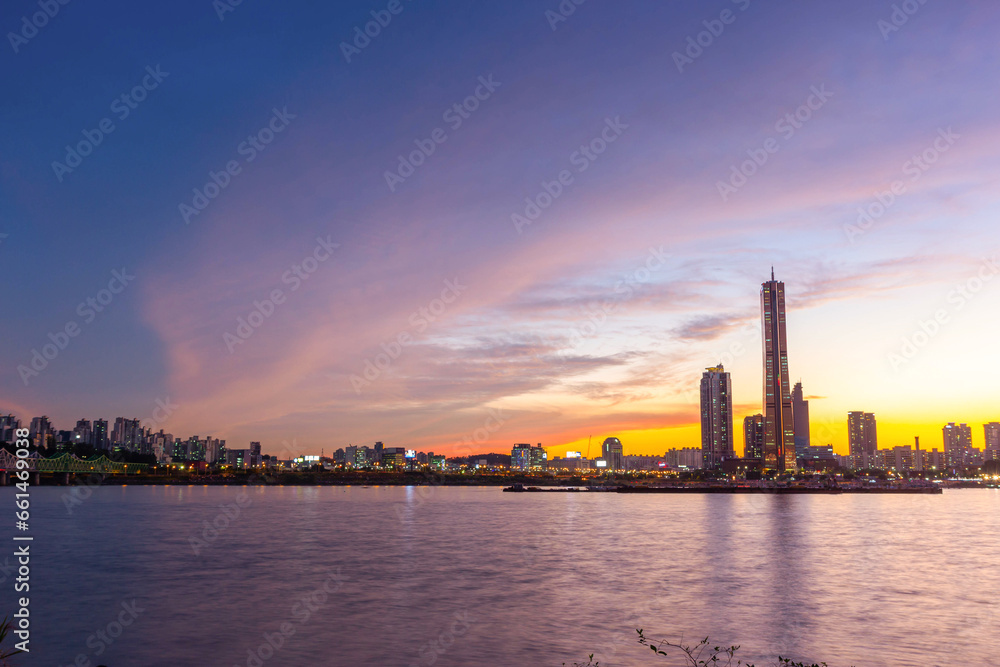 View beside the Han River overlooking the skyscrapers at Yeouido after sunset, South Korea.