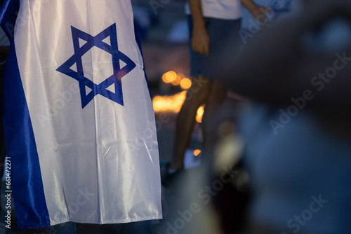 Lisbon, Portugal October 10, 2023. The flag of Israel in close-up on the background of a rally in support of Israel at dusk © KONSTANTIN SHISHKIN