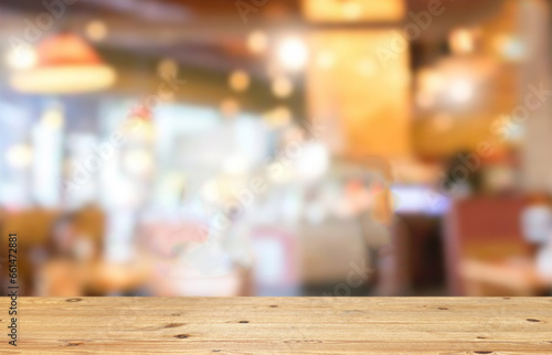 Wooden table top on blur night restaurant background.For montage product display or design key visual layout.View of copy space. © TE