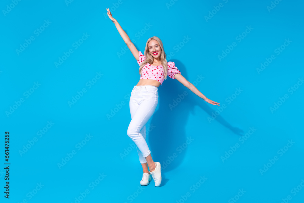 Full length photo of lovely young lady raise hands have fun dressed stylish pink cherry print garment isolated on blue color background