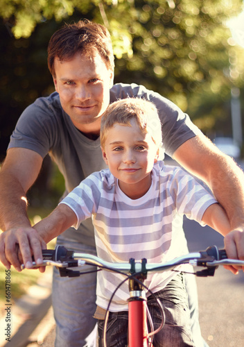 Bicycle, ride and father help child with bike and learning on the road and parent support kid in vacation or holiday. Smile, development and dad together with son and teaching outdoor skills
