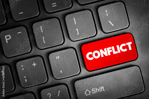 Conflict - struggle and a clash of interest, opinion, or even principles, text concept button on keyboard photo