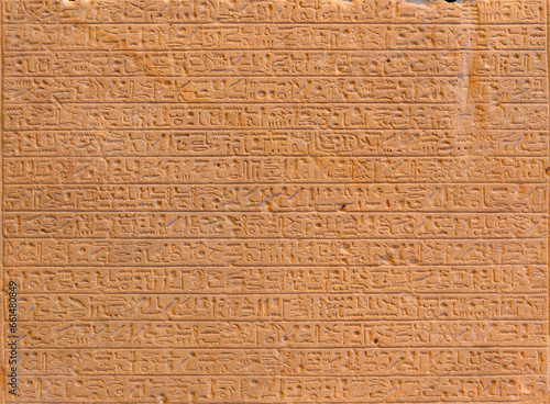 Ancient Egyptian script on red sandstone in pyramid