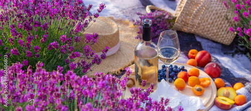 wine, fruits, berries, cheese, glasses picnic in lavender field Selective focus