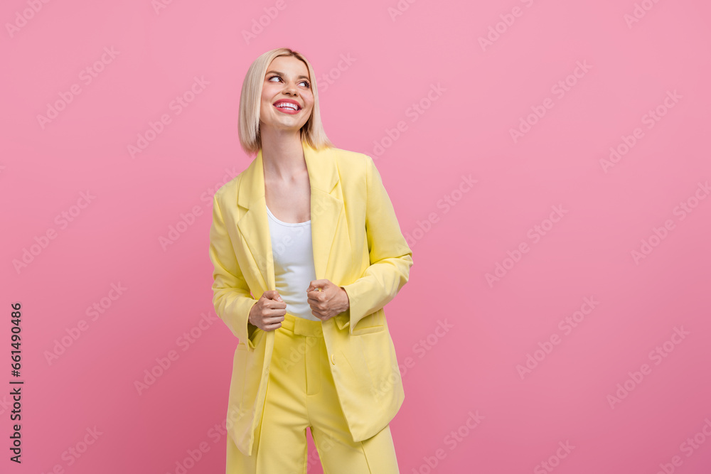 Photo of stunning cheerful minded person beaming smile look empty space ad isolated on pink color background Photo of stunning cheerful minded person beaming smile look empty space ad isolated on pink color background