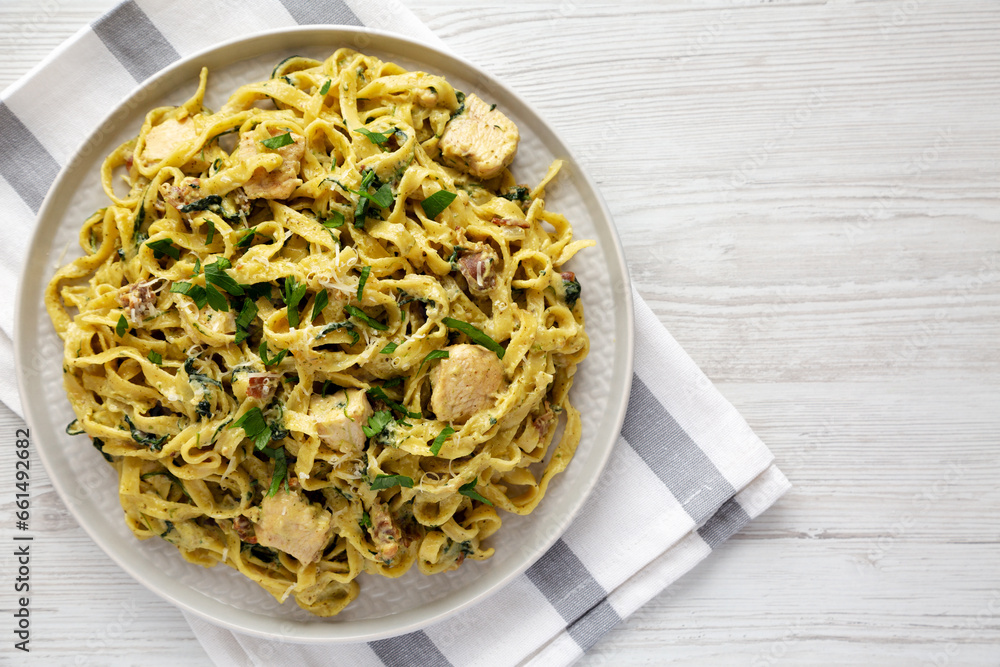 Homemade Creamy Chicken Bacon Pesto Pasta on a Plate, top view. Flat lay, overhead, from above. Copy space.