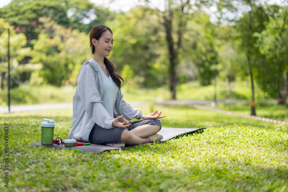 Young Asian woman revitalized through park yoga, meditation, aligning body, mind, restoring energy. Young Asian woman revitalized through park yoga, meditation, aligning body, mind, restoring energy.