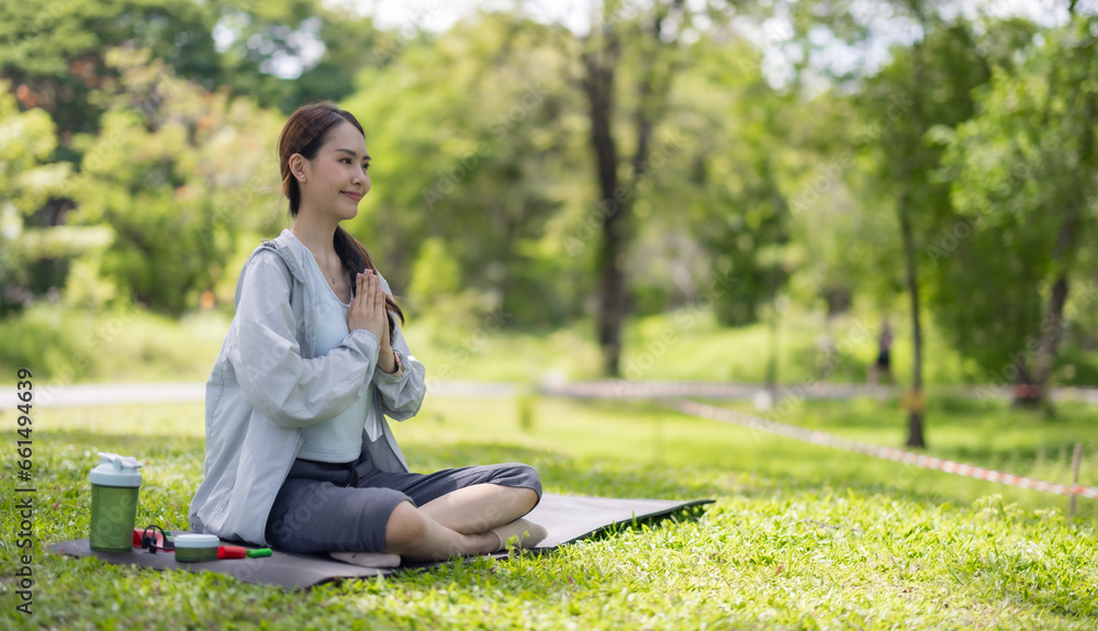 Young Asian woman revitalized through park yoga, meditation, aligning body, mind, restoring energy. Young Asian woman revitalized through park yoga, meditation, aligning body, mind, restoring energy.