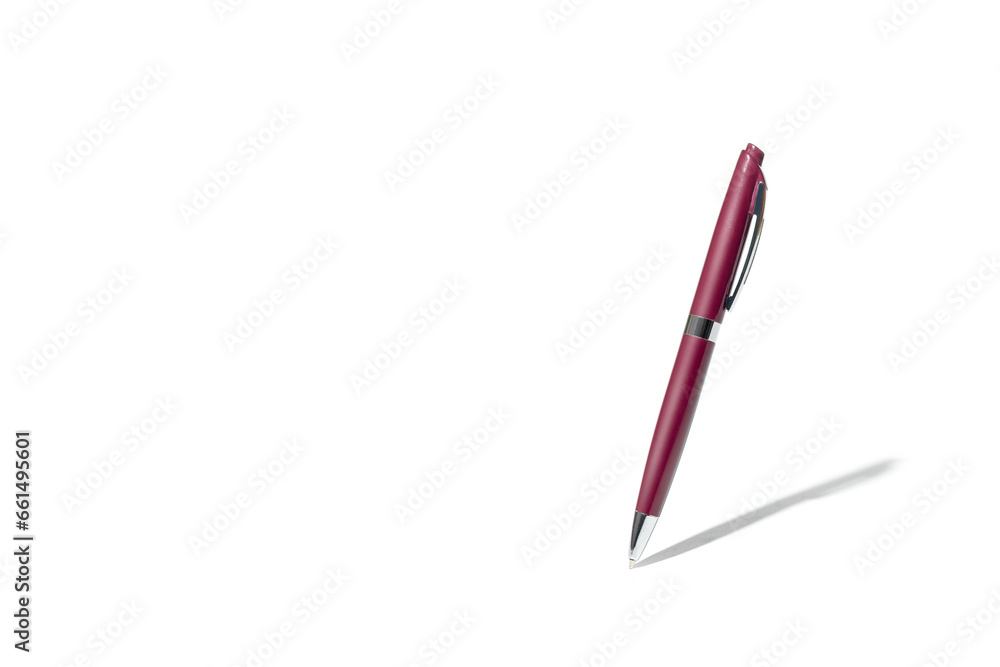 Detailed red classic ballpoint pen writing on white surface with its shadow. Isolated on white background with clipping path