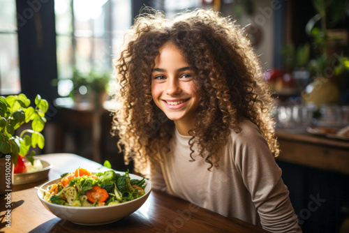 Confident teenager girl enjoying a healthy meal and smiling.