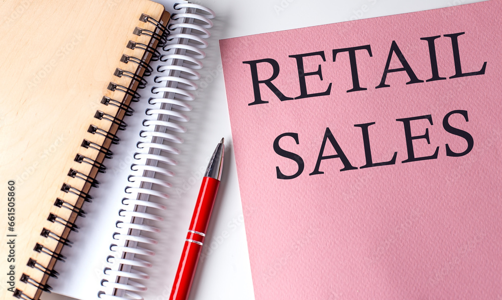 RETAIL SALES word on the pink paper with office tools on white background RETAIL SALES word on the pink paper with office tools on white background