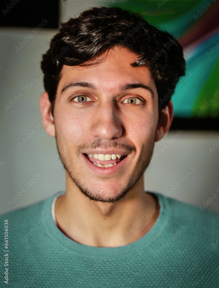 Surprised, happy handsome young man looking at camera, at home