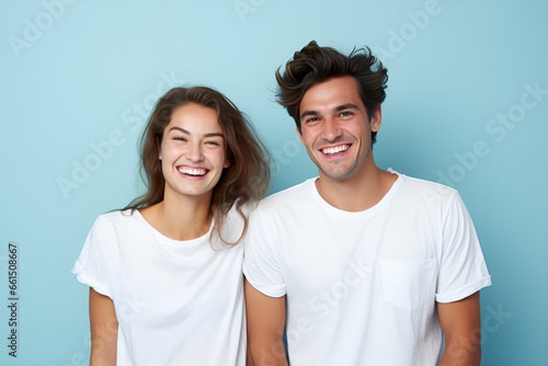 Young fictional white couple smiling. Isolated on a plain blue background. Generative AI. photo