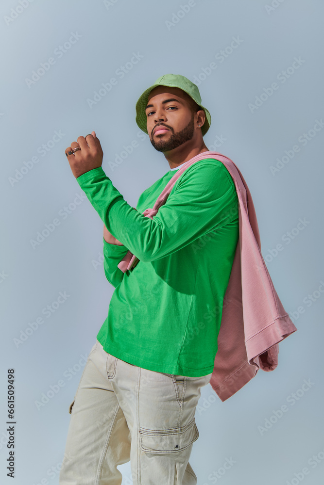 dynamic photo of young african american man with sweatshirt tied on his shoulders, fashion concept dynamic photo of young african american man with sweatshirt tied on his shoulders, fashion concept