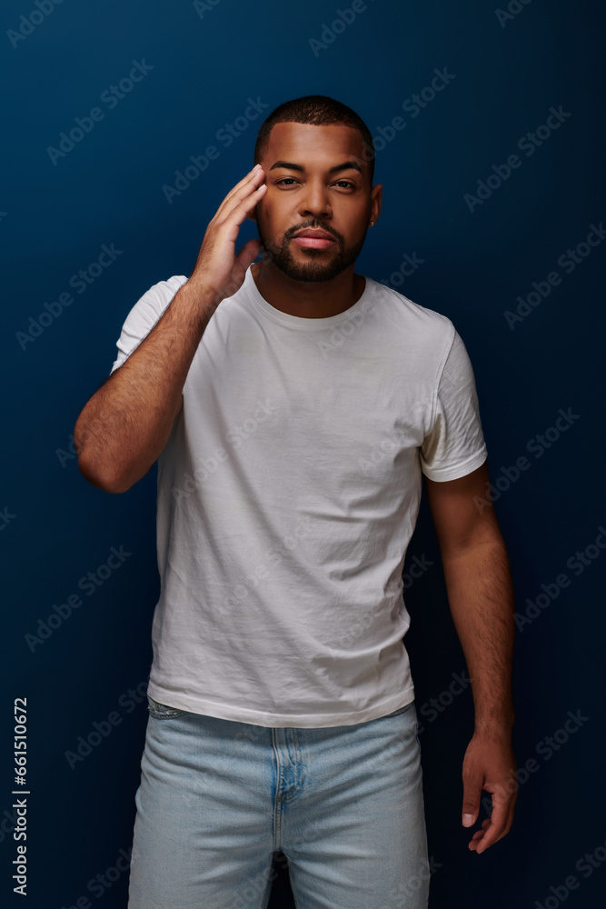 african american man in casual outfit with hand to forehead looking at camera, fashion concept