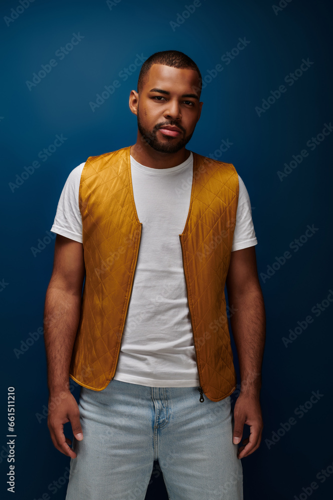 handsome bearded man standing still looking at camera on dark blue background, fashion concept handsome bearded man standing still looking at camera on dark blue background, fashion concept