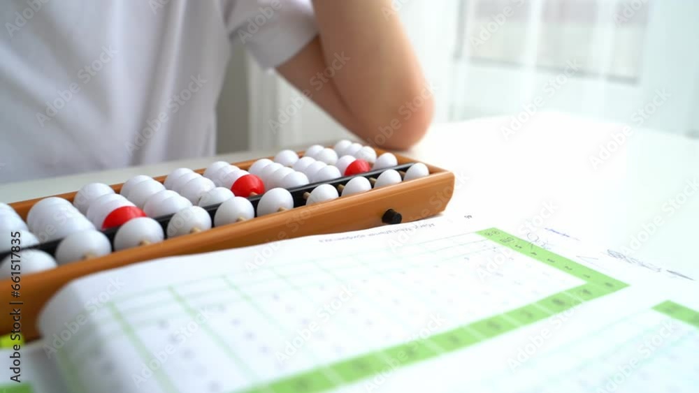 The boy is engaged in abacus, mental arithmetic for children The boy is engaged in abacus, mental arithmetic for children
