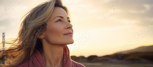 Stunning mature lady outdoors at sundown photo