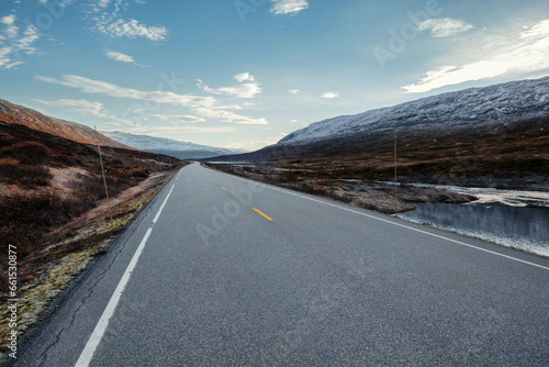 View of a road on high altitude leading through the norweigian mountains in autumn. photo