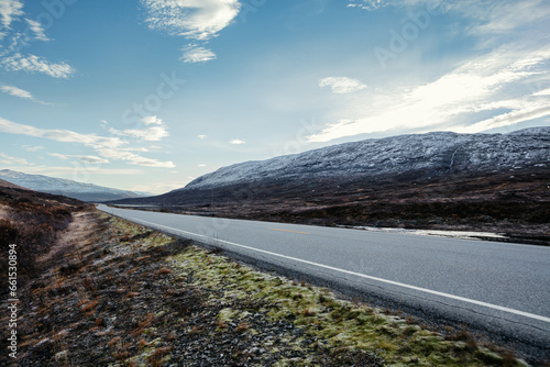 View of a road on high altitude leading through the norweigian mountains in autumn. photo