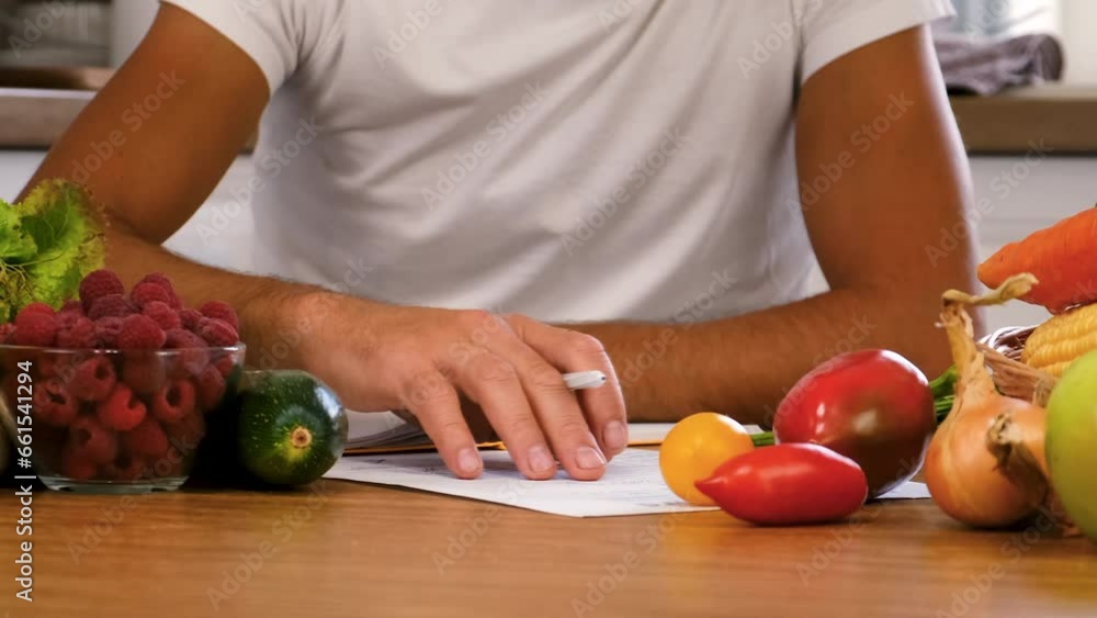 The nutritionist writes a diet nutrition plan. Selective focus. The nutritionist writes a diet nutrition plan. Selective focus.