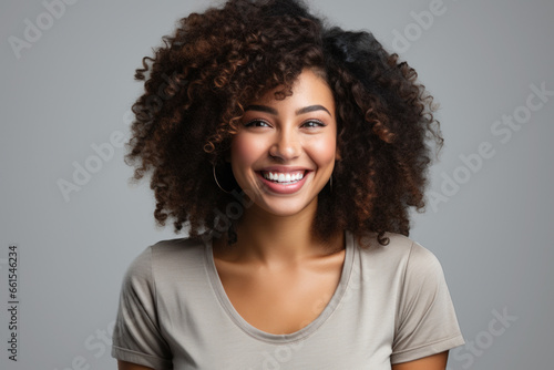 Young happy african american woman in white t-shirt isolated on white background © sofiko14