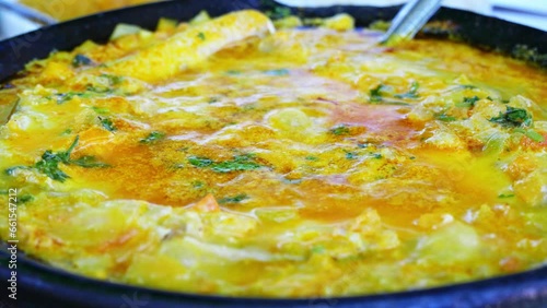 Traditional Bahian fish stew, simmering in a rich blend of coconut milk and palm oil, showcasing the authentic flavors of Brazil. 