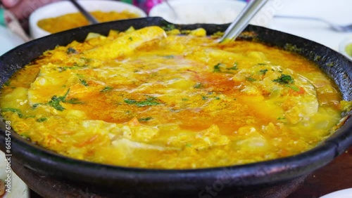 Traditional Bahian moqueca, simmering in a rich blend of coconut milk and palm oil, showcasing the authentic flavors of Bahia, Brazil. 
