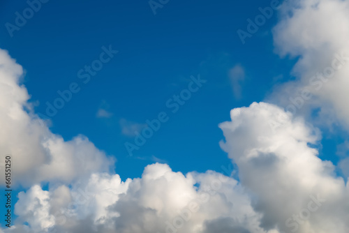 Fluffy high cumulus white clouds in blue sky  natural background