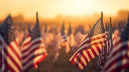 A peaceful sunrise over a field of flags, each representing a fallen hero, with copy space, blurred background