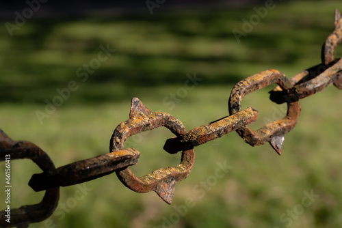 nostalgic rusted barrier chain against a blurred background