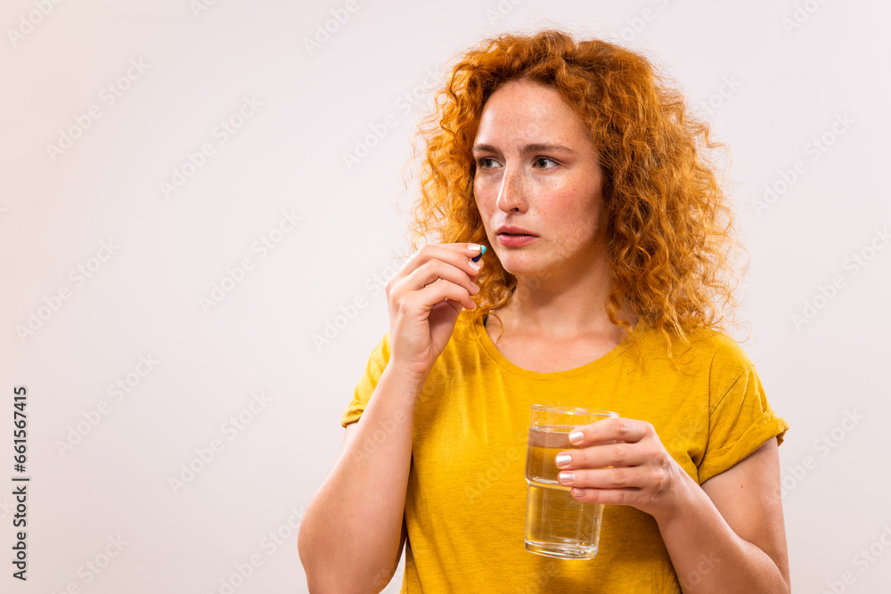 Portrait of ginger woman taking pills. Portrait of ginger woman taking pills.