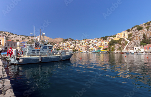 Colorful houses on the slopes of the mountains on the island of Symi on a bright sunny day.