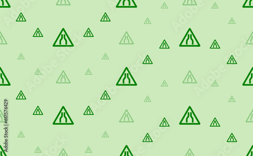 Seamless pattern of large and small green road narrowing signs. The elements are arranged in a wavy. Vector illustration on light green background