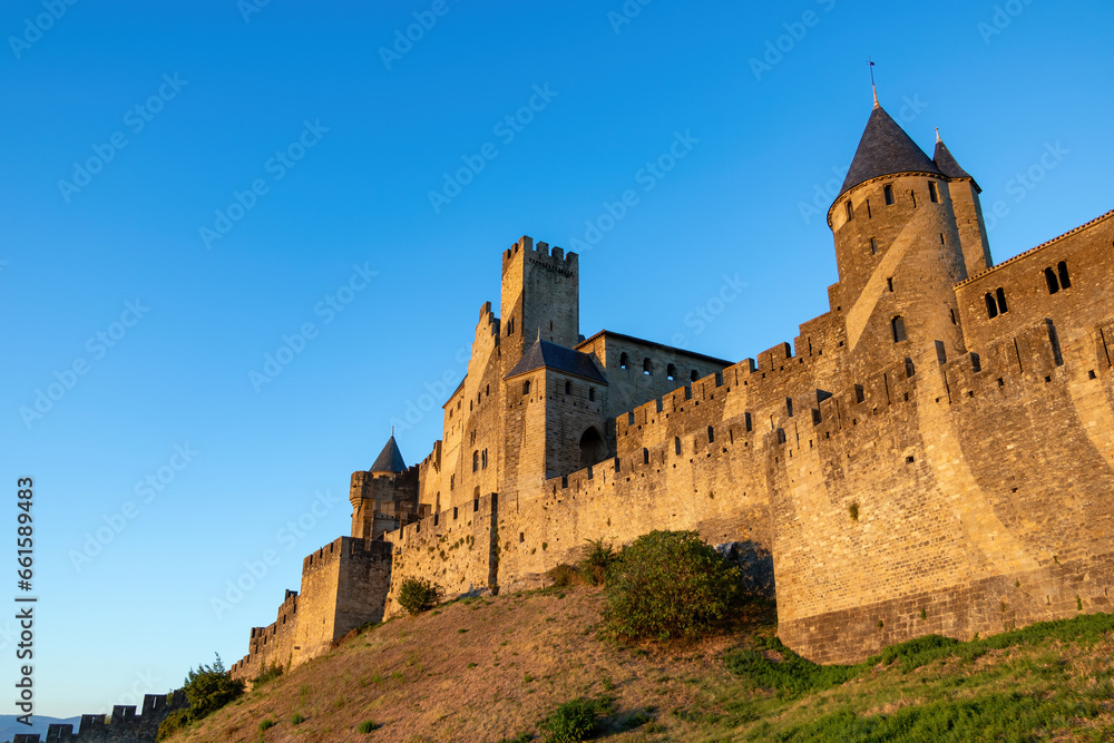 View point of west side of Cite de Carcassonne in sunset, stone walls of the fortification
