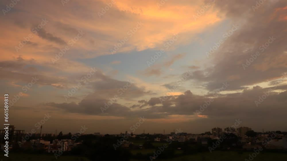 4KTime lapse sunset cityscape,Timelapse Night to Day,Golden sunset light at gray evening clouds over town 4KTime lapse sunset cityscape,Timelapse Night to Day,Golden sunset light at gray evening clouds over town