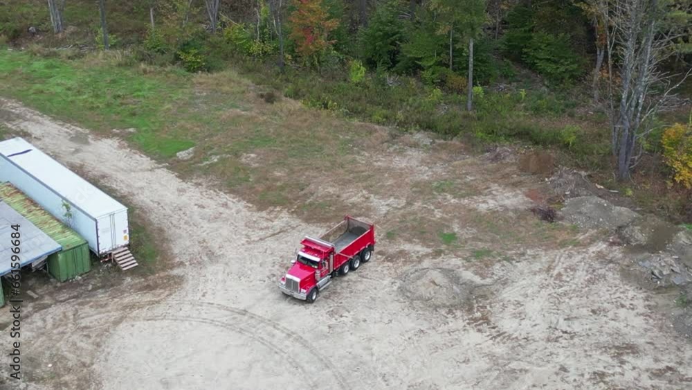 Red Dump Truck leaving work site. View from air Red Dump Truck leaving work site. View from air