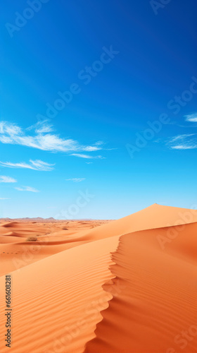 Desert sand dunes. Blue sky and clouds. Africa.