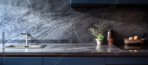 Blue motion kitchen cabinets with a granite countertop paired with stone gray worktops and dark cabinets With copyspace for text
